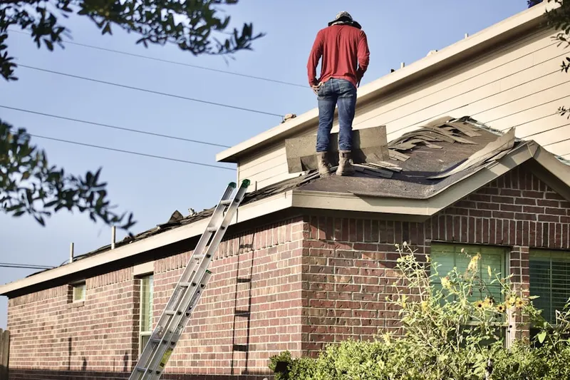 Professional roofer working on a residential roof in Meadowoods of Davidsonville
